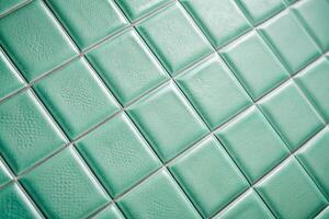 Depth of field tile in mint color with texture and even seams background texture of tiles photo
