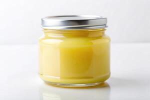 Lemon curd in jar with label on white background photo