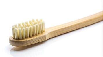 Macro shot of a natural bamboo toothbrush isolated on white background photo