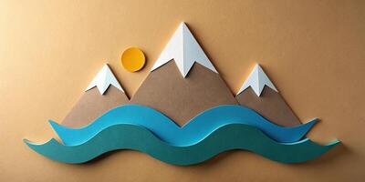Paper cutout of mountain range with wave and sun in background photo