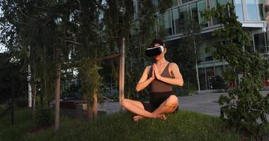 Beautiful girl doing yoga in the digital universe. Virtual reality. VR glasses. video