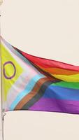 Rainbow flag waving on a clear day. Multicolored flag with stripes in the colors of the rainbow, often used as a symbol of LGBT pride. Slow motion video