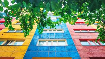 A multi-colored building with many windows and trees in front of it video