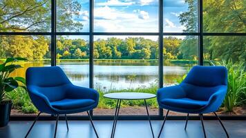 Two blue chairs and a table in front of a large window with a view of a lake video