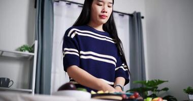 Handheld low angle view shot, Young Asian woman standing wash the avocado in the bowl on table at home, Clean and safe fruit for eating. video