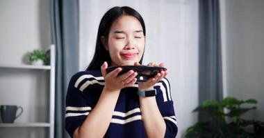Handheld shot, Happy Asian woman standing and smelling plate of food for lunch on dining table at home. Home lifestyle. video