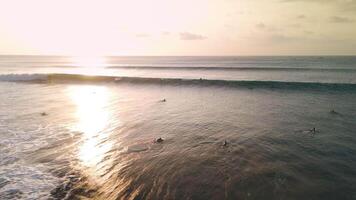 Drone view with surfing swell waves. Perfect waves with surfers in ocean at Bali video
