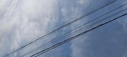 A view of a power line and a sky with clouds photo