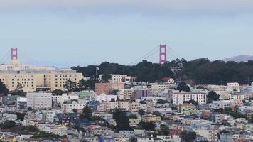 Aerial view of the Golden Gate Bridge surrounded by Fog in San Francisco, California, USA. View from the downtown of San Francisco with houses and buildings in the foreground. video
