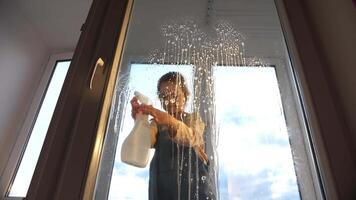 A person standing in front of a window with water on it video