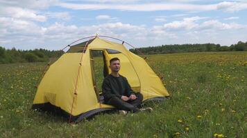 a man in a tent resting from work at a computer, laptop video