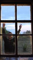 vertical man shows greetings through the window. The man greets with gestures. video