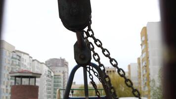 Swing in the playground. Swinging. Close up on chain. video