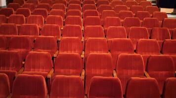 many empty bright red seats in the theater, cinema. Empty seats video
