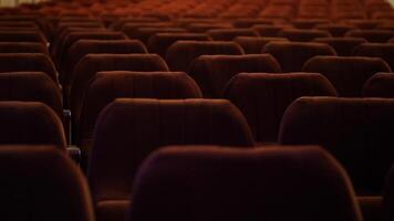 row of empty spectator chairs with raised seats in an empty auditorium video