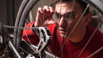 a man is looking for a malfunction, a breakdown in a bicycle video