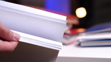 leafing through a stack of documents. Finding the required document video