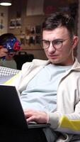 vertical child distracts dad from working on the computer at home video