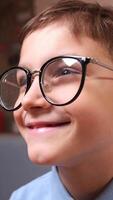 vertical boy with glasses, playing a game with a controller video