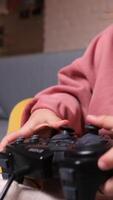 vertical Little girl playing a game on a console, using a controller video