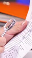 vertical reading a document with a magnifying glass video
