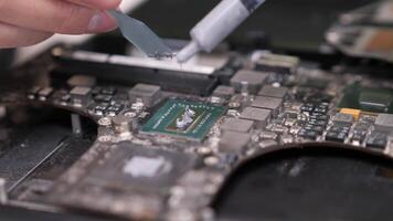 close-up applying thermal paste to computer processor chip. Computer service video