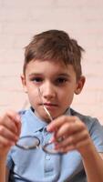 vertical Tired child feeling eye strain after using computer video
