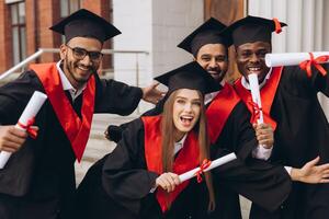 Group of Happy Graduates Celebrating with Diplomas in Hand on Graduation Day photo