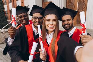 Happy Graduates Celebrating with Diplomas in Hand, Capturing a Joyous Milestone Moment Together photo