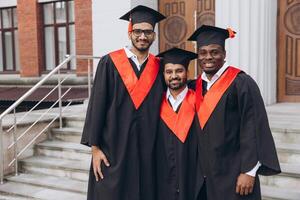 Group of Graduates Celebrating in Cap and Gown on University Steps Smiling Proudly photo