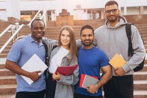 Diverse Group of College Students Smiling Together with Notebooks Outdoors on Campus Steps photo