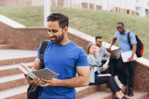 Smiling Indian Student with Books on College Campus Steps Enjoying Study Time photo