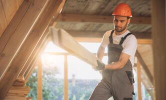 Process of construction new and modern modular house. Worker man in special protective uniform wear working on building development industry of energy efficient property. photo