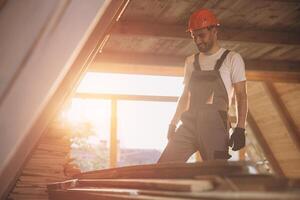 Process of construction new and modern modular house. Worker man in special protective uniform wear working on building development industry of energy efficient property. photo