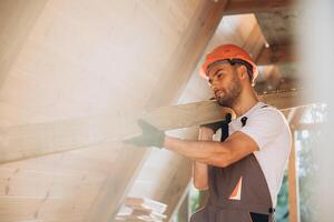 Process of construction new and modern modular house. Worker man in special protective uniform wear working on building development industry of energy efficient property. photo