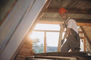 Process of construction new and modern modular house. Worker man in special protective uniform wear working on building development industry of energy efficient property. photo