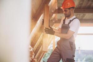 Process of construction new and modern modular house. Worker man in special protective uniform wear working on building development industry of energy efficient property. photo