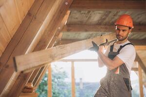 Process of construction new and modern modular house. Worker man in special protective uniform wear working on building development industry of energy efficient property. photo