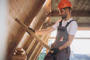 Process of construction new and modern modular house. Worker man in special protective uniform wear working on building development industry of energy efficient property. photo