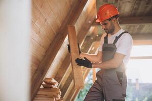 Process of construction new and modern modular house. Worker man in special protective uniform wear working on building development industry of energy efficient property. photo