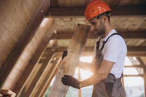 Process of construction new and modern modular house. Worker man in special protective uniform wear working on building development industry of energy efficient property. photo