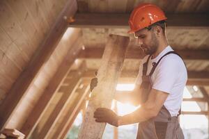 Process of construction new and modern modular house. Worker man in special protective uniform wear working on building development industry of energy efficient property. photo
