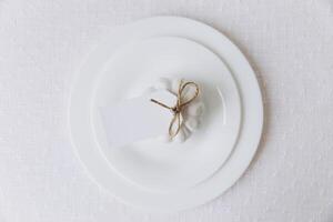 Thanksgiving set. Table setting, white plates with pumpkin, mockup, top view photo