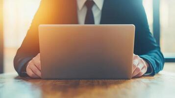 A focused businessman uses a laptop to manage ISO standards and quality assurance in a techsavvy environment. photo