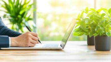 A focused businessman takes notes at his home office desk, capturing essential details for effective planning and strategy. photo