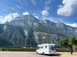 Motorhome against the Italian mountain landscape on a sunny day - traveling on wheels photo