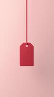 Rectangular red blank paper tag label price tag with hanging satin rope isolated pink photo