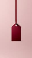 Rectangular red blank paper tag label price tag with hanging satin rope isolated pink photo