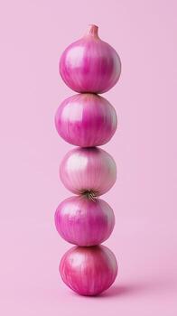A stack of red onion balancing to top with solid bacground photo