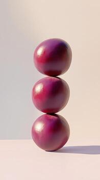 A stack of plum fruit balancing on top with solid background photo